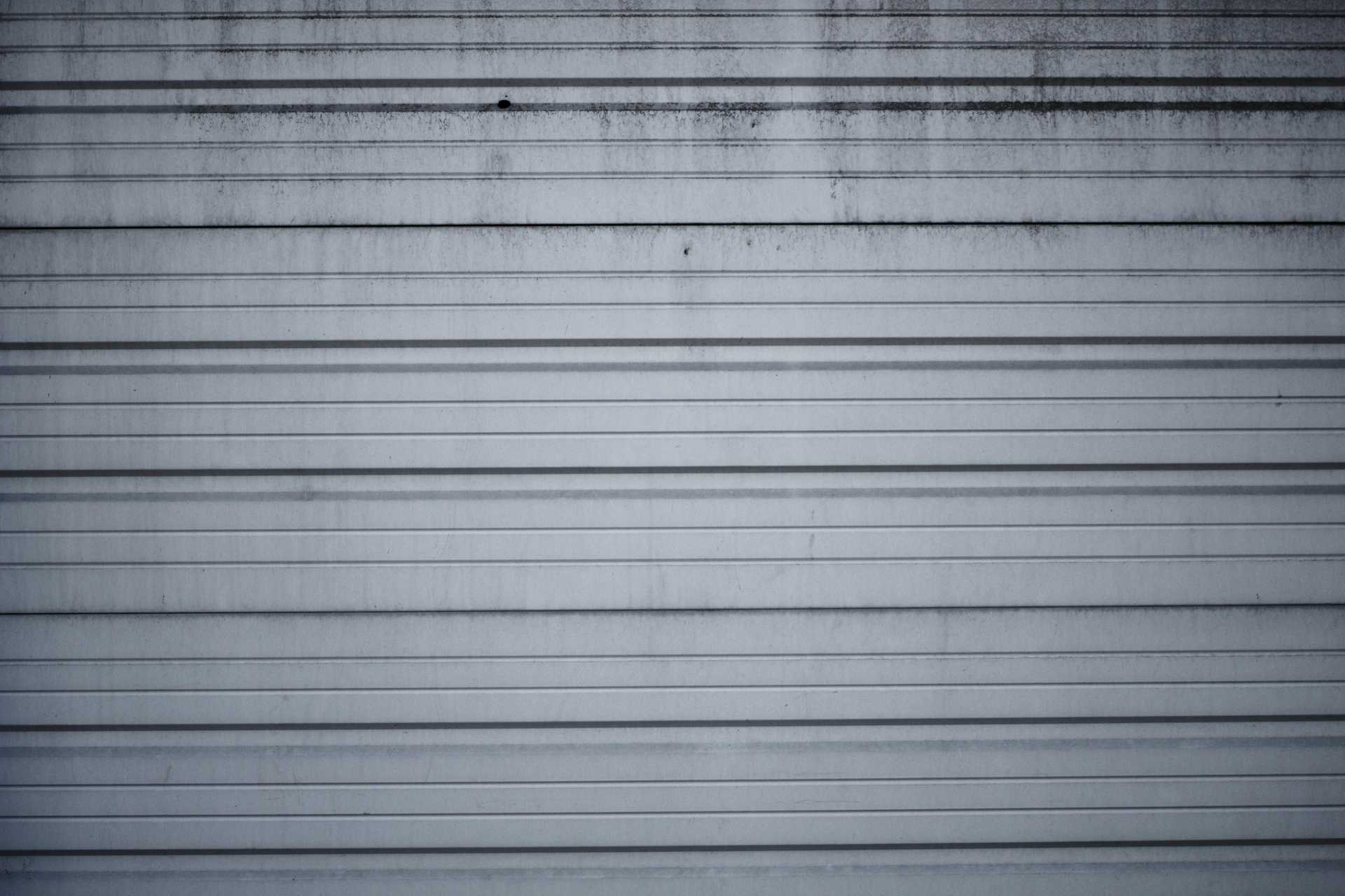 A close-up of a white and gray striped garage door